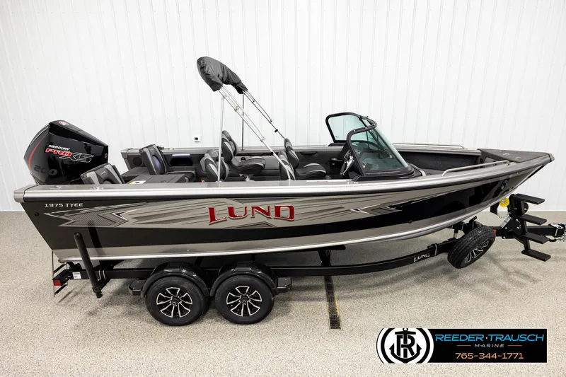 The Image of 2026 Lund 1975 Tyee boat on trailer, featuring sleek design and modern outboard motor. - 1