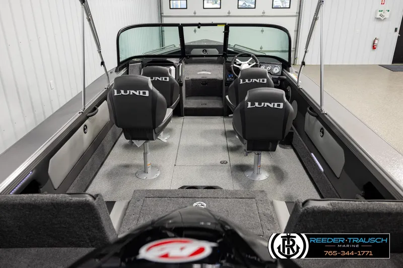 Slide: The Image of Interior view of a 2026 Lund 1975 Tyee boat with four seats and steering console. - 12