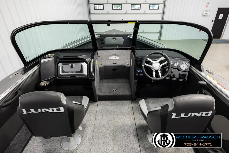 Slide: The Image of Interior of 2026 Lund 1975 Tyee boat with steering console and seating. - 13