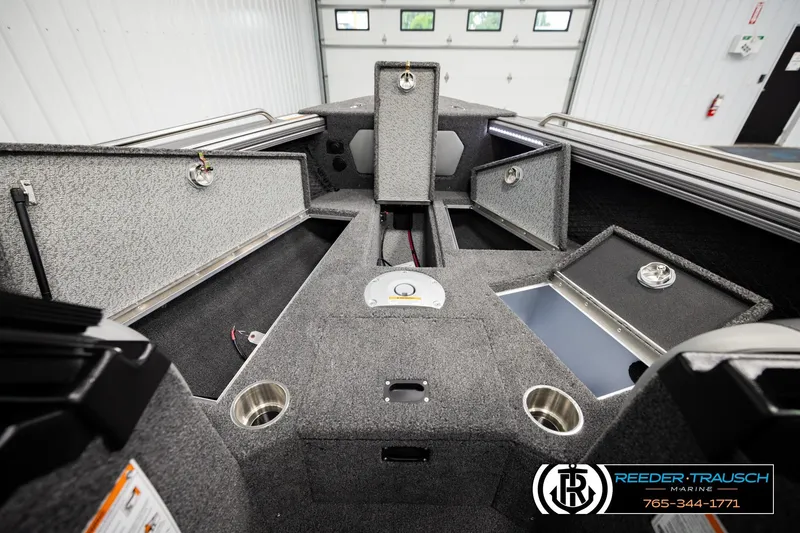 Slide: The Image of Interior of 2026 Lund 1975 Tyee boat with open storage compartments and cup holders. - 23