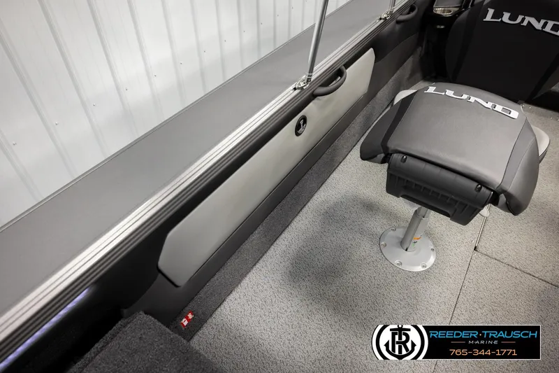 Slide: The Image of Interior of 2026 Lund 1975 Tyee boat with branded seating and carpeted flooring. - 27