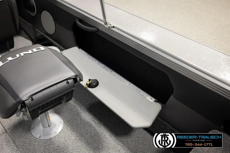 Slide: The Image of Lund 1975 Tyee 2026 boat interior with seating and storage compartment. - 30
