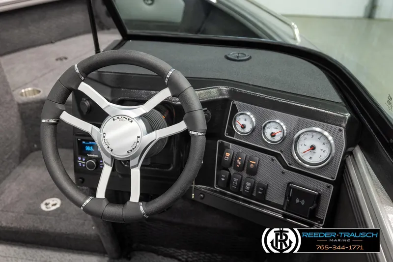 Slide: The Image of Interior of 2026 Lund 1975 Tyee boat with steering wheel and dashboard controls. - 31