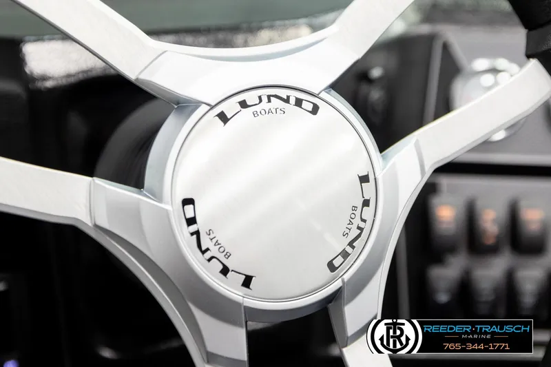 Slide: The Image of Steering wheel of 2026 Lund 1975 Tyee boat, featuring sleek design and branding. - 33