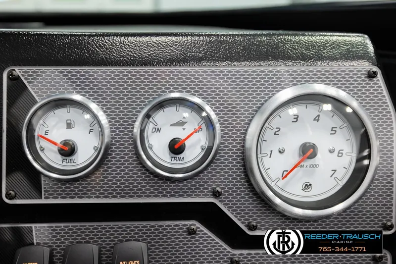 Slide: The Image of Dashboard gauges of a 2026 Lund 1975 Tyee boat, featuring fuel, trim, and RPM indicators. - 35
