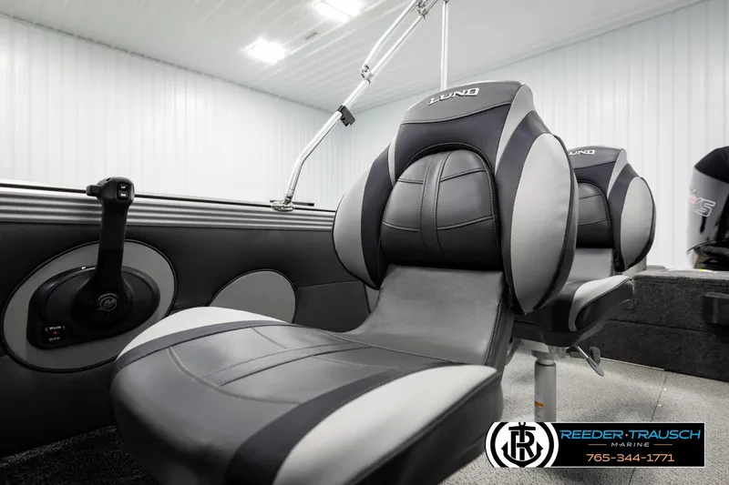 Slide: The Image of 2026 Lund 1975 Tyee boat interior with sleek, modern seating and control panel. - 39