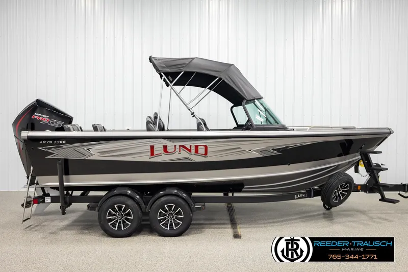 Slide: The Image of 2026 Lund 1975 Tyee boat with canopy, dual axle trailer, and Mercury Pro XS engine. - 4