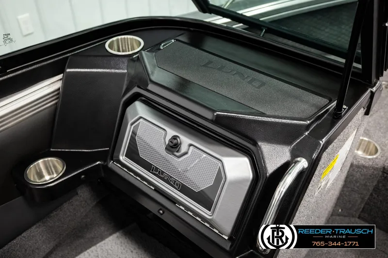 Slide: The Image of Interior of 2026 Lund 1975 Tyee boat featuring storage compartment and cup holders. - 41