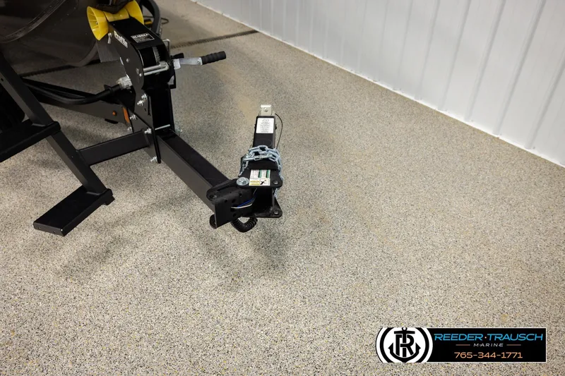 Slide: The Image of Trailer hitch of a 2026 Lund 1975 Tyee boat in a showroom. - 50