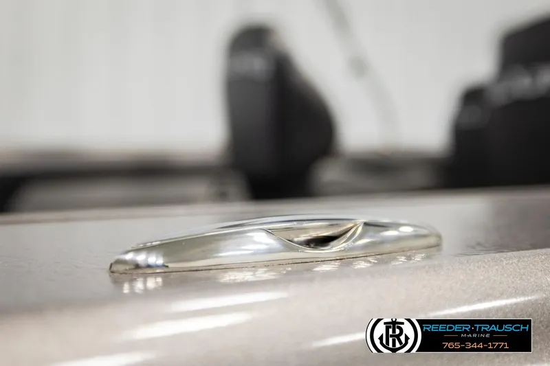 Slide: The Image of Close-up of a 2026 Lund 1975 Tyee boat detail with Reeder-Trausch Marine logo. - 56