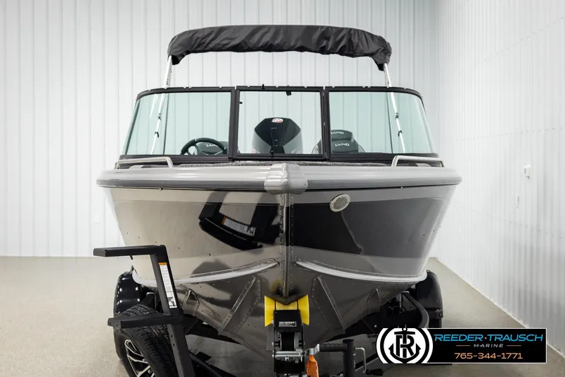 Slide: The Image of Front view of a 2026 Lund 1975 Tyee boat in a showroom. - 7