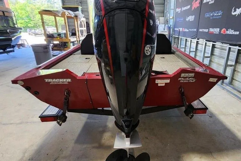 Slide: The Image of 2025 Tracker Pro Team 190 TX Tournament Edition boat in a garage, rear view. - 2