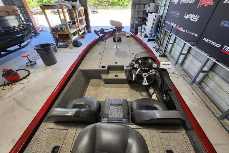 Slide: The Image of 2025 Tracker Pro Team 190 TX Tournament Edition boat interior in a garage setting. - 3