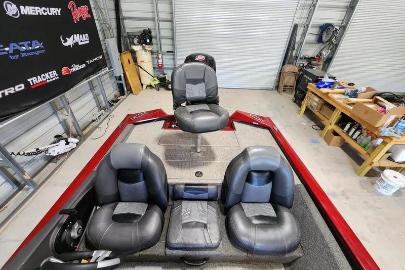 Slide: The Image of 2025 Tracker Pro Team 190 TX Tournament Edition boat interior with four seats in a garage. - 4