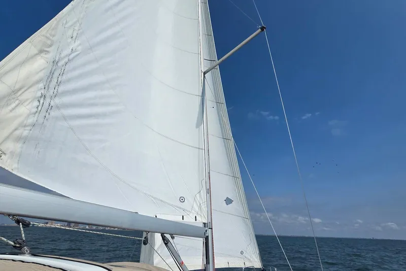 Slide: The Image of Sailing on a 2018 Beneteau Oceanis 38.1 with white sails against a clear blue sky. - 10
