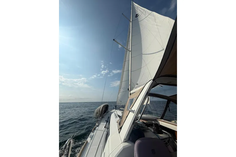 Slide: The Image of 2018 Beneteau Oceanis 38.1 sailing on open sea under clear blue sky. - 11
