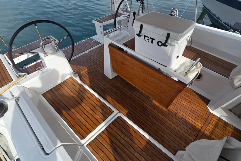 Slide: The Image of Cockpit of 2018 Beneteau Oceanis 38.1 sailboat with wooden flooring and steering wheel. - 17
