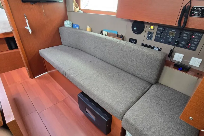 Slide: The Image of Interior of 2018 Beneteau Oceanis 38.1 yacht with gray seating and control panel. - 22