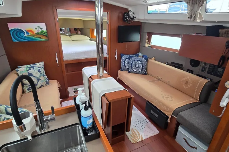 Slide: The Image of Cozy interior of 2018 Beneteau Oceanis 38.1 sailboat with seating, bed, and kitchenette. - 23