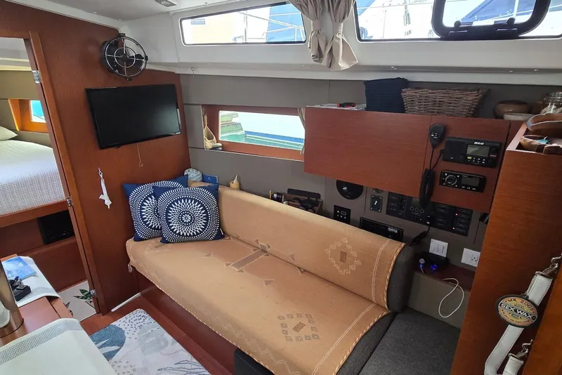 Slide: The Image of Interior of a 2018 Beneteau Oceanis 38.1 yacht with cozy seating and modern amenities. - 24