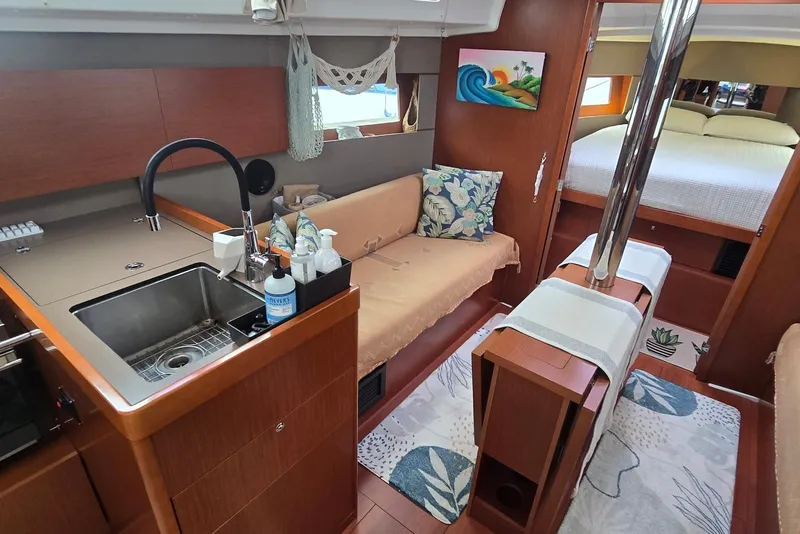 Slide: The Image of Interior of 2018 Beneteau Oceanis 38.1 yacht with kitchen, seating, and bedroom. - 26