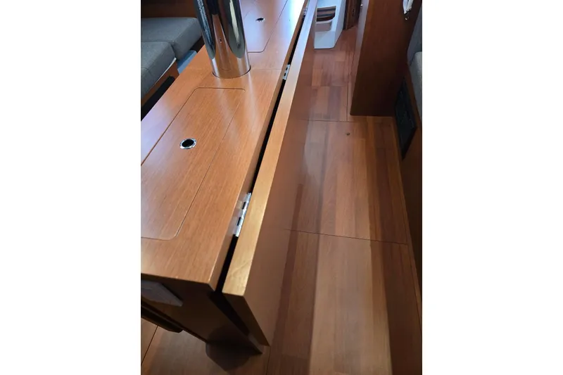 Slide: The Image of Interior view of 2018 Beneteau Oceanis 38.1 sailboat with wooden flooring and seating. - 31