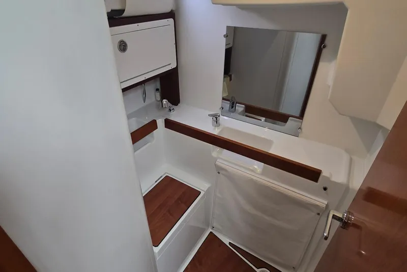 Slide: The Image of 2018 Beneteau Oceanis 38.1 yacht bathroom with modern fixtures and wooden accents. - 32