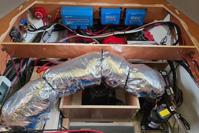 Slide: The Image of Engine compartment of a 2018 Beneteau Oceanis 38.1 sailboat, showcasing wiring and components. - 36
