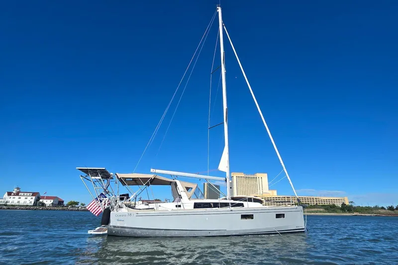 Slide: The Image of 2018 Beneteau Oceanis 38.1 sailboat on calm water under clear blue sky. - 4