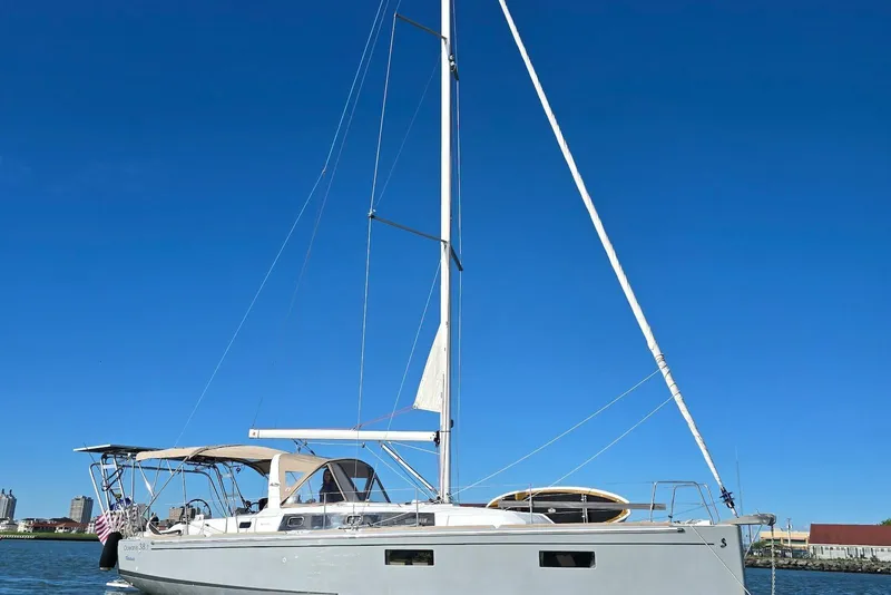 Slide: The Image of 2018 Beneteau Oceanis 38.1 sailboat on calm water under clear blue sky. - 6