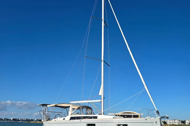 Slide: The Image of 2018 Beneteau Oceanis 38.1 sailboat on calm water under clear blue sky. - 7