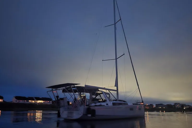 Slide: The Image of 2018 Beneteau Oceanis 38.1 sailboat at dusk on calm waters. - 8