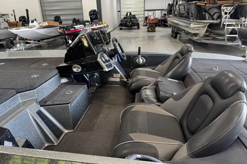 Slide: The Image of 2020 Ranger Z185 boat interior with dual seats and control panel in showroom. - 13