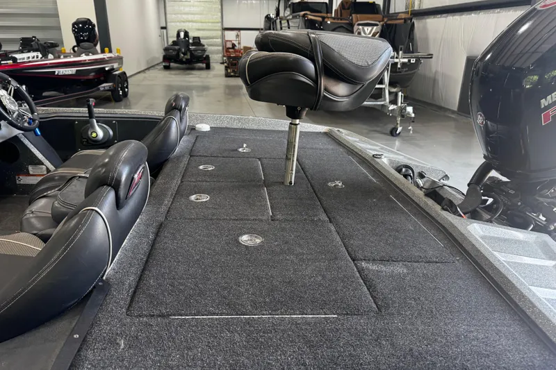 Slide: The Image of 2020 Ranger Z185 boat interior with seating and storage compartments in a showroom. - 14