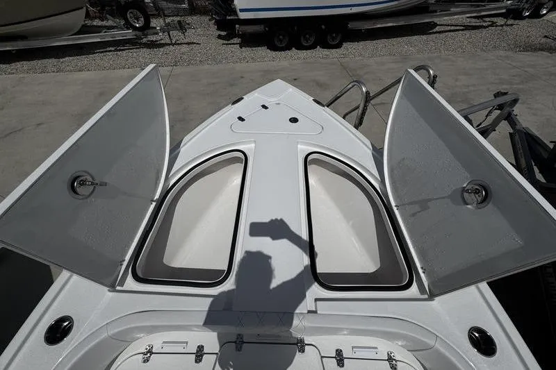 Slide: The Image of 2026 Blazer Bay 2440 boat deck with open storage compartments and shadow. - 11
