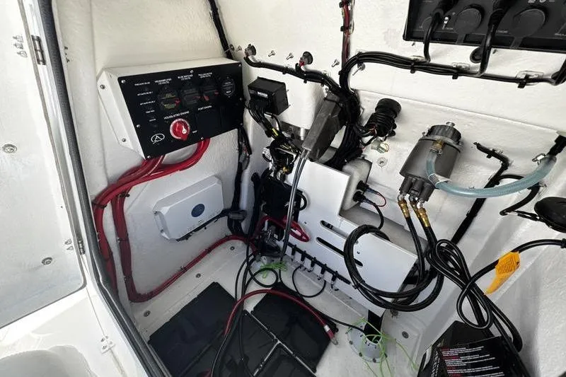 Slide: The Image of Electrical system inside a 2026 Blazer Bay 2440 boat, featuring wiring and control panels. - 18