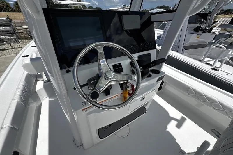 Slide: The Image of 2026 Blazer Bay 2440 boat helm with steering wheel and modern controls. - 20