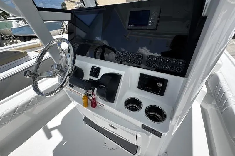 Slide: The Image of 2026 Blazer Bay 2440 boat dashboard with steering wheel and control panel. - 21