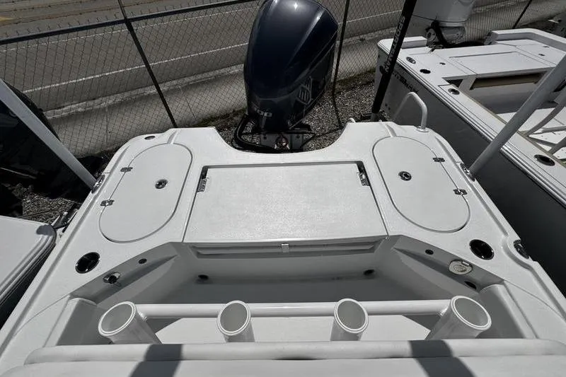 Slide: The Image of 2026 Blazer Bay 2440 boat deck with motor and storage compartments. - 27