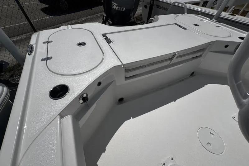 Slide: The Image of 2026 Blazer Bay 2440 boat deck with storage compartments and seating area. - 28