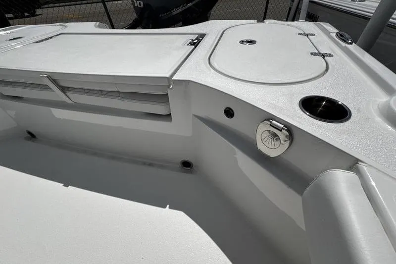 Slide: The Image of Interior view of 2026 Blazer Bay 2440 boat, featuring storage compartments and cup holder. - 29