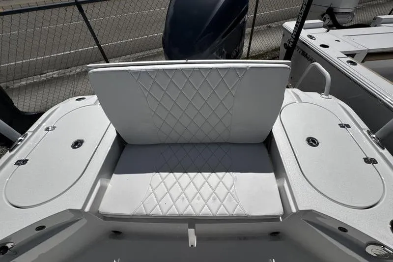 Slide: The Image of 2026 Blazer Bay 2440 boat with white diamond-stitched seating and storage compartments. - 30