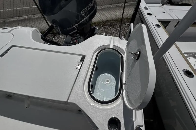 Slide: The Image of 2026 Blazer Bay 2440 boat with open livewell and Yamaha outboard motor. - 32