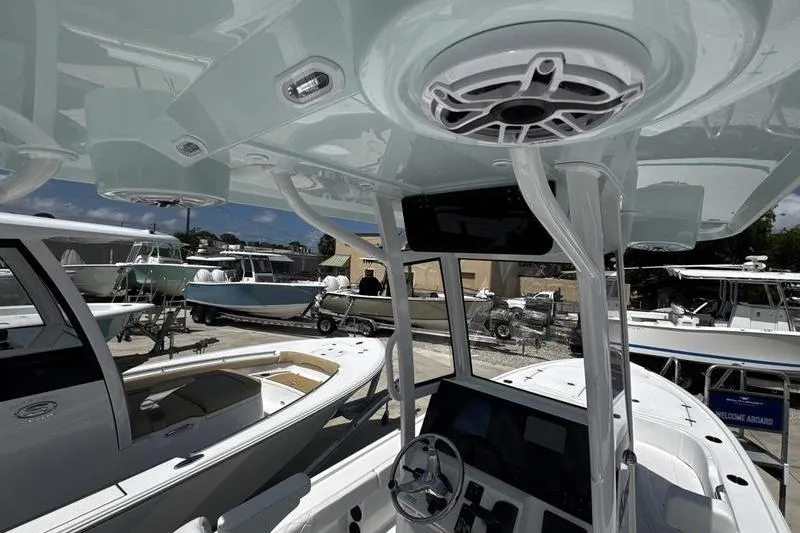 Slide: The Image of 2026 Blazer Bay 2440 boat interior with modern dashboard and overhead speakers. - 33