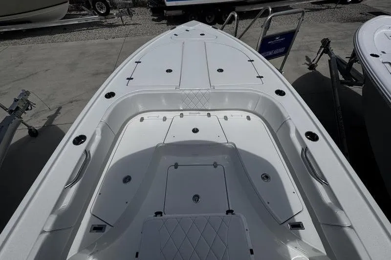 Slide: The Image of 2026 Blazer Bay 2440 boat deck with storage compartments and seating. - 6