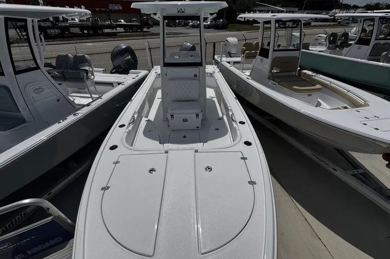 Slide: The Image of 2026 Blazer Bay 2440 boat displayed in a marina, surrounded by other vessels. - 8