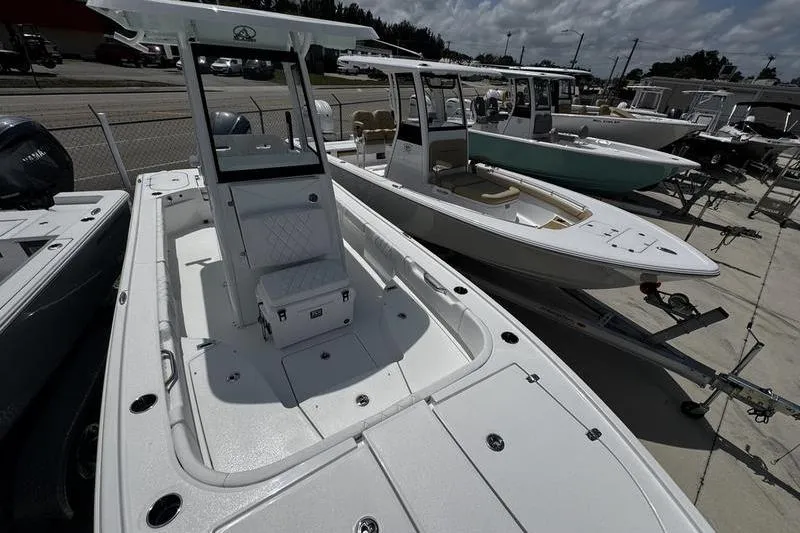 Slide: The Image of 2026 Blazer Bay 2440 boats displayed in a showroom under a cloudy sky. - 9