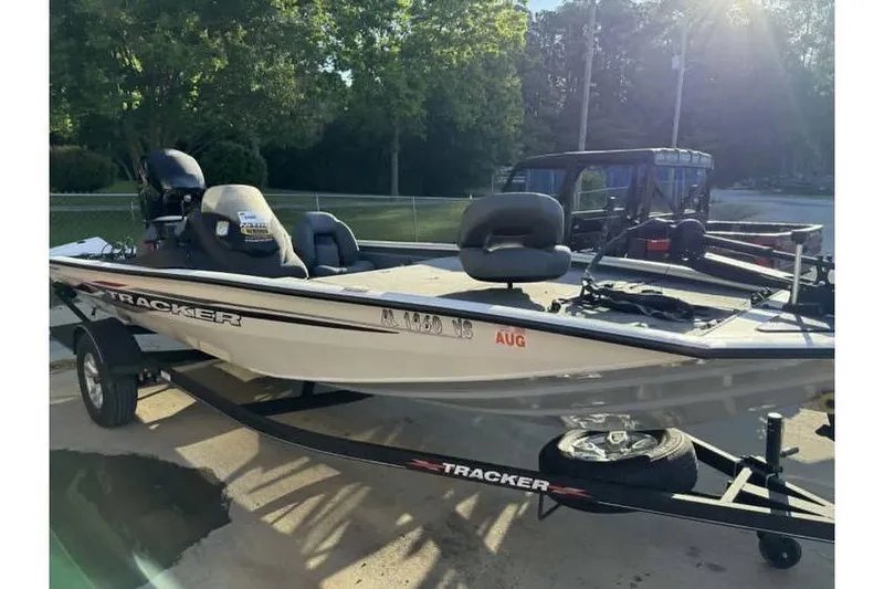 The Image of 2023 Tracker Pro Team 195 TXW Tournament Edition boat on trailer in sunny outdoor setting. - 0