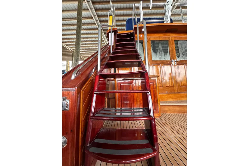 Slide: The Image of Staircase on 1980 Bertram 58 Convertible yacht with polished wood finish. - 16