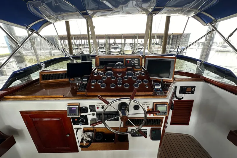 Slide: The Image of Cockpit of a 1980 Bertram 58 Convertible yacht with navigation instruments and steering wheel. - 20